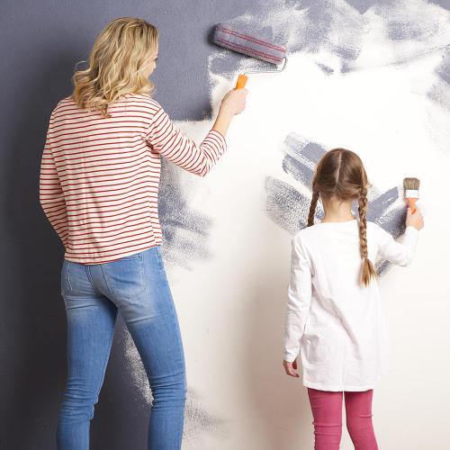 Family Painting a wall - Airdrie Paint and Decor